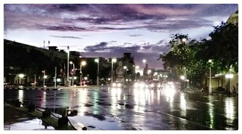 View of illuminated street light against cloudy sky