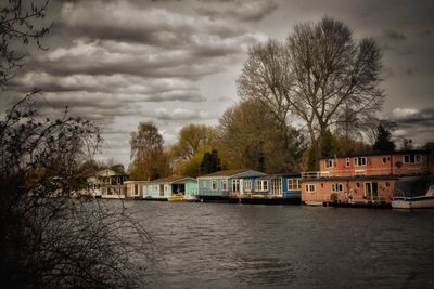 Bridge over river against cloudy sky