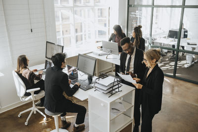 High angle view of corporate colleagues working together at office