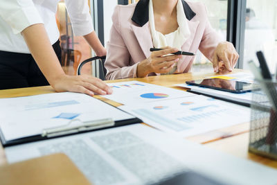 Midsection of woman using mobile phone