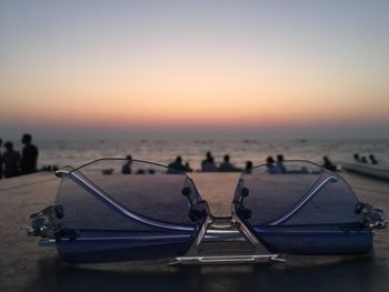 Boats moored on sea against sky during sunset