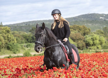 Man riding horse on field