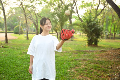 Portrait of young woman standing in park