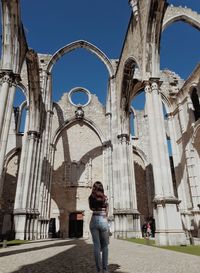 Woman standing by buildings in city