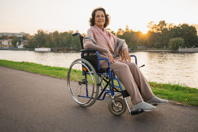 Happy senior woman in wheelchair. old cheerful positive woman in chair for people with disability