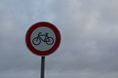 Low angle view of road sign against sky