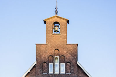 Sunset on a brick church bell tower in the city of utrecht, the netherlands. travel destination.