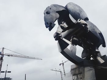 Low angle view of sculpture against sky