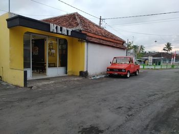 View of street and buildings against sky