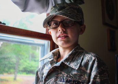 Portrait of boy wearing military uniform
