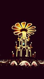 Low angle view of illuminated ferris wheel