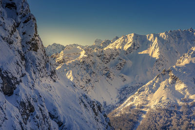 Scenic view of snowcapped mountains against clear sky