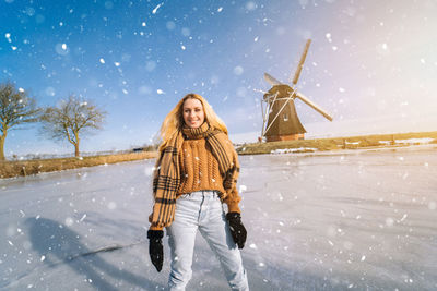 Full length of woman standing on snow