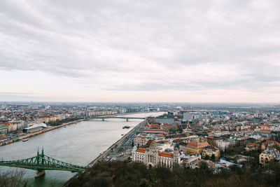 High angle view of river amidst buildings in city against sky