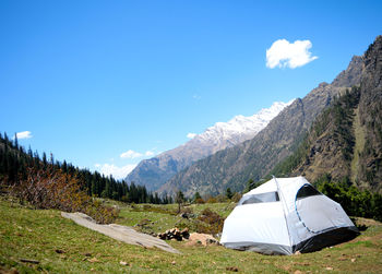 Tent on field against mountain range