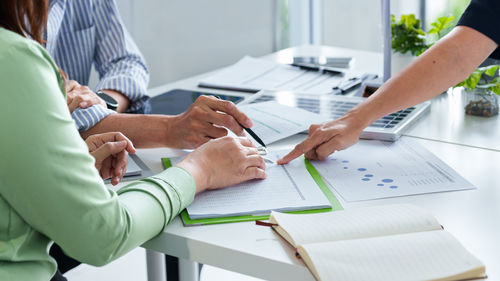 Midsection of business colleagues working at office