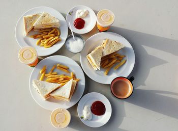 High angle view of fast food with drinks on table