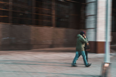 Full length of man walking on road