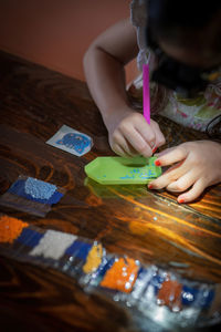 Close-up of hand painting on table