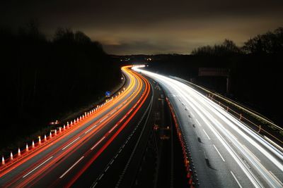 High angle view of light trails on highway at night