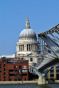 Low angle view of 
millennium bridge with st paul cathedral in the background. london, uk.
