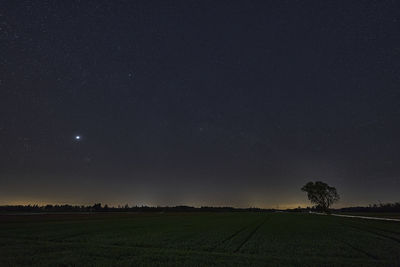 Scenic view of field against sky at night