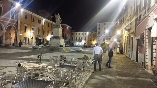 People walking on city street at night