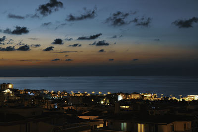 High angle view of illuminated buildings against sky at sunset