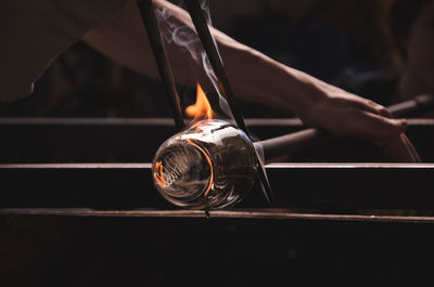 Close-up of person making glassware