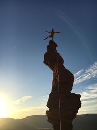 Low angle view of silhouette people on mountain