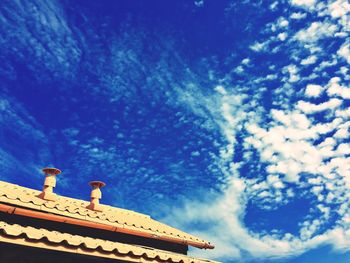 Low angle view of building against cloudy sky