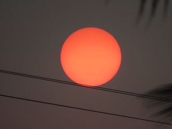 Low angle view of illuminated lights against sky during sunset