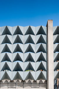 Close-up of modern building against clear blue sky