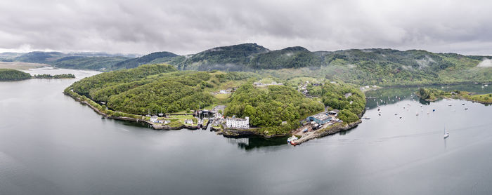 High angle view of river and mountains against sky