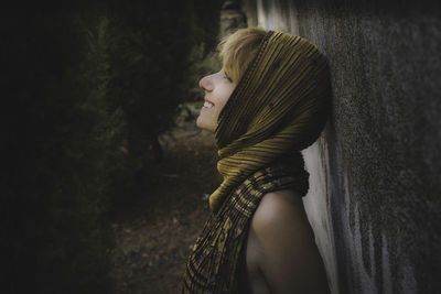 Close-up of young woman by wall