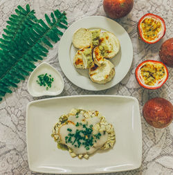 High angle view of breakfast served on table with potato and coconut milk