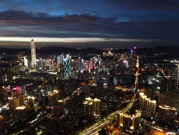 High angle view of illuminated city against sky at night