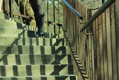 Low section of man walking on staircase