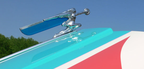 Close-up of faucet against blue sky