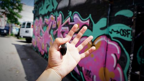 Close-up of cropped hand holding painting