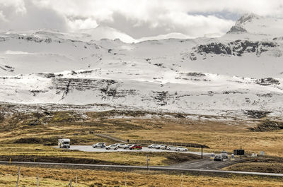 Parking lot with cars near the kirkjufellfoss waterfall