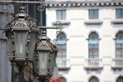 Low angle view of lighting equipment against buildings