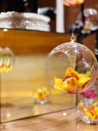 Close-up of yellow glass on table