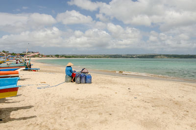 Scenic view of beach against cloudy sky