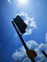 Low angle view of road sign against sky