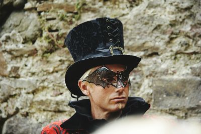 Portrait of man wearing hat against wall