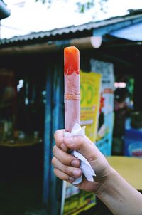 Close-up of hand holding ice cream