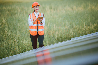 Portrait of young man standing on field