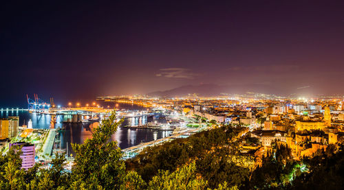 High angle view of illuminated buildings against sky at night