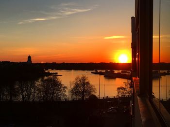 Scenic view of lake against orange sky